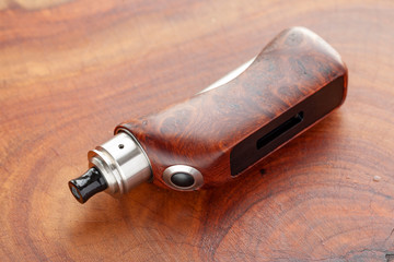 high end natural stabilized wood box mods with rebuildable dripping atomizer on natural wood...