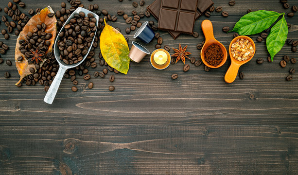 Coffee beans ,coffee capsule and coffee powder on dark wooden background. Top view with copy space.