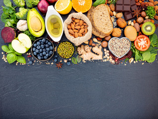 Ingredients for the healthy foods selection. The concept of healthy food set up on dark stone background.