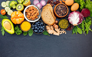 Ingredients for the healthy foods selection. The concept of healthy food set up on dark stone background.