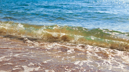 sandy beach and blue sea wave. Beautiful natural background. Tourism and travel.