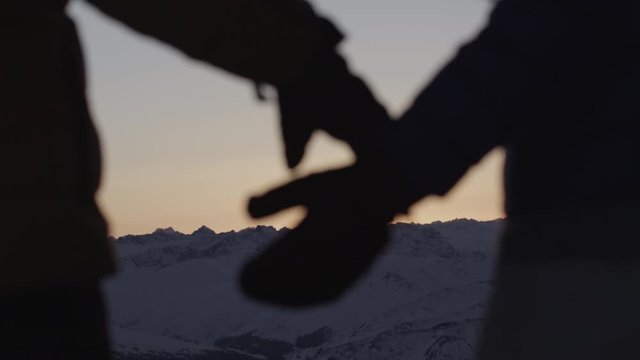 couple holding hands in alpine sunset silvretta mountains
