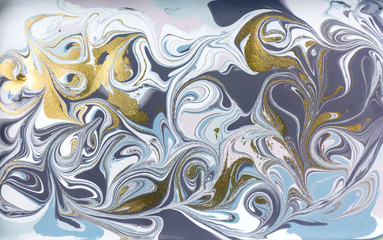 Blue and purple marble pattern with golden glitter. Abstract liquid background.