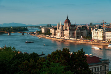 Fototapeta premium Hungarian Parliament in Budapest buy the Danube river at sunset