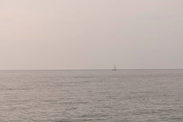 Sailboat on the horizon at sea. Sailboat in the Adriatic sea.