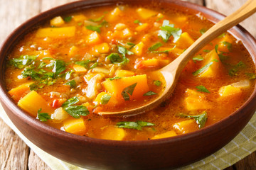 African spicy vegetarian sweet potato with lentil soup close-up in a bowl on the table. horizontal