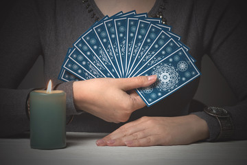Tarot cards in fortune teller hands. Divination. Future reading.
