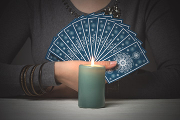 Tarot cards in fortune teller hands. Divination. Future reading.