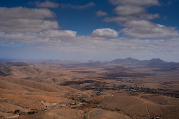 Fototapeta na wymiar A view over the hilly landscape of the Canary Island Fuerteventura