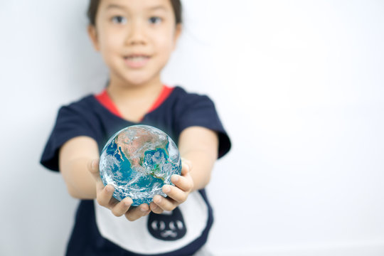 Little girl holding globe on her hands on white background. Elements of this image furnished by NASA.