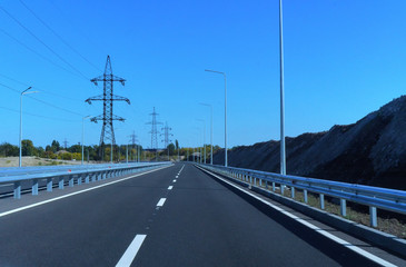 Fototapeta premium Landscape with rocks, sunny sky with clouds and beautiful asphalt road