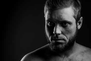 Fototapeta na wymiar Portrait of a man with a beard on a black background