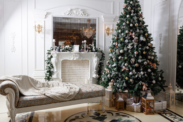 Christmas morning. classic luxury apartments with a white fireplace, decorated christmas tree. Holiday card.