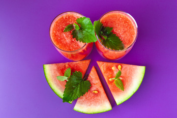 Watermelon smoothie on a purple background. Super food for vegetarians. Suitable for banner, poster, web site, advertisement.