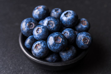 Close up of fresh organic blueberries on black background
