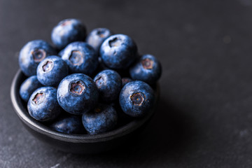 Close up of fresh organic blueberries on black background