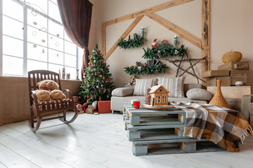 Calm image of interior modern home living room decorated christmas tree and gifts, sofa, table covered with blanket.