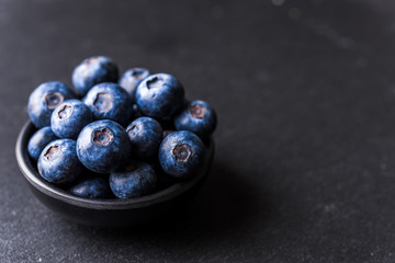 Close up of fresh organic blueberries on black background