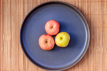 Plate with apples. Autumn layout. Fruit apples. Autumn picture. . Apples and autumn leaves