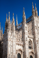 Fototapeta premium Duomo Di Milano - Cathedral (catholic church) is one of the world's largest building in the country. Close-up view of marble details and statues on the exterior building. Milan, Lombardy, Italy.