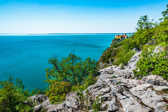 Gulf of Trieste. High cliffs Between boats, karst rocks and ancient castles. Duino. Italy