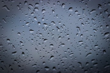 Abstract of Rain drops on window glass, natural water pattern background , selective focus.