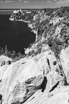 Gulf of Trieste. High cliffs Between boats, karst rocks and ancient castles. Black and white. Duino. Italy