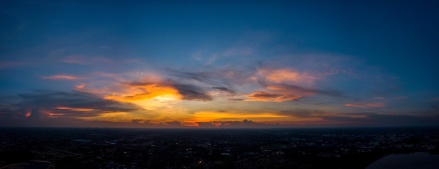 Panorama Top view Aerial photo from flying drone over village in Thailand.Top view beautiful Sunset with dramatic sky clouds.