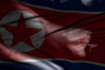 pretty picture of dark North Korea flag with folds lying flat in shadows with light spots on it - any occasion flag 3d illustration..