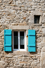 Old window with wooden blue painted shutter