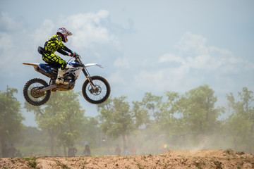 Naklejka premium Motocross Rider Jump in a blue sky with clouds.Enduro bike rider in action. 