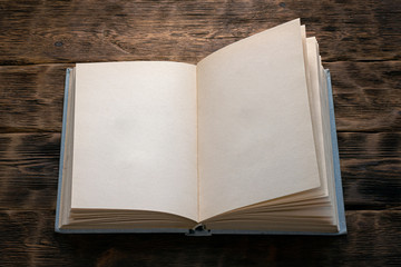 Open blank page book on brown background.