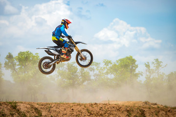 Motocross Rider Jump in a blue sky with clouds.Enduro bike rider in action. 