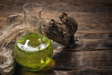 Green magic potion on a witch desk background.