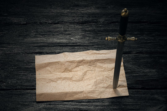 Treasure map old parchment mock up and dirk in a pirate wooden table.