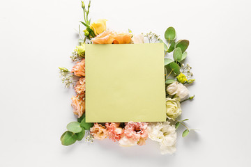 Beautiful composition with flowers and blank card on white background