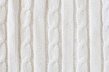 White vertical knitted woolen background. Knitting pattern