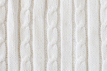 White vertical knitted woolen background. Knitting pattern