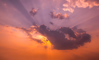 Panorama Sunlight with dramatic sky. Cumulus sunset clouds with sun setting down on dark background.Vivid orange cloud sky.