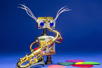 DIY robot toy with saxophone in his hand. Funny mechanical toy character.