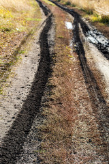 Mud blurred road, autumn field.