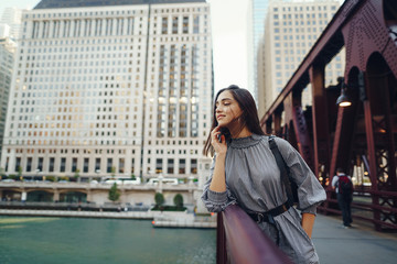 young lady crossing the bridge while exploring chicago