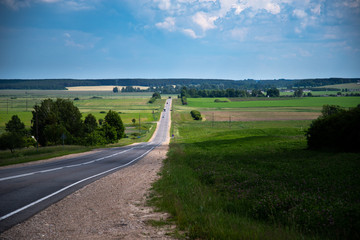 Green grass and car road. Countryside scenery