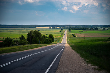 Green grass and car road. Countryside scenery