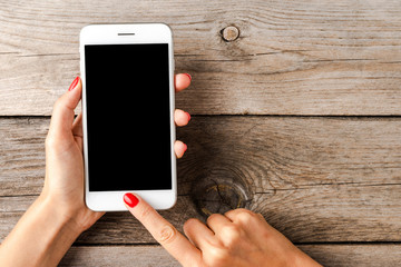 Woman using smartphone with empty black screen.