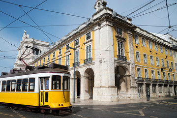 Fototapeta na wymiar Public yellow tram at Praça do Comércio, Lisbon, Portugal