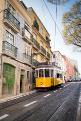 Naklejka na ściany i meble Tourist yellow tram riding around Bairro Alto neighborhood, Lisbon, Portugal