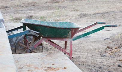 Old dirty metal wheelbarrow
