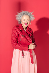 Beautiful mature woman wearing leather jacket feeling happy