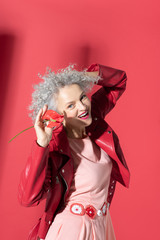 Woman wearing dress with stylish belt laughing while posing